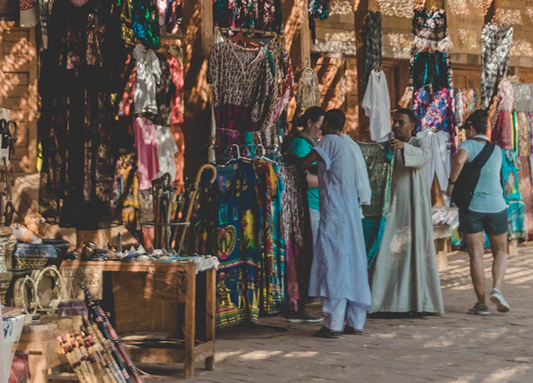 A hawker selling his clothing wares in one of Egypts many markets.