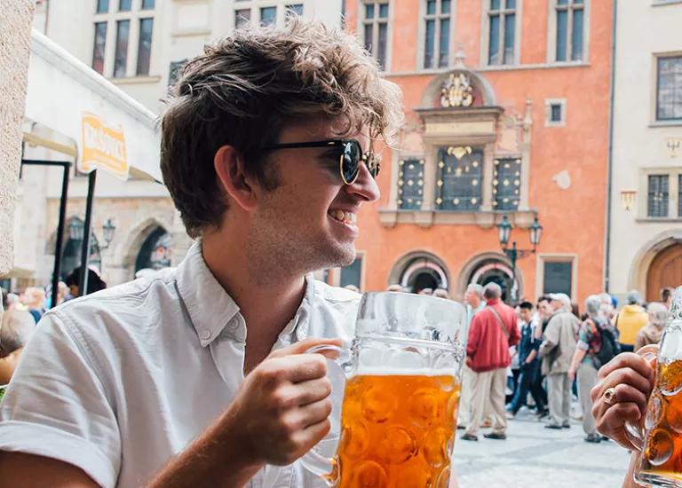 Two Topdeck travelers sharing a pint of lager together in a bar in Prague.