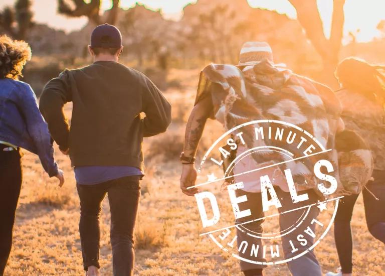 A group of Topdeck travelers running off into the sunset on a tour of the Australian Outback.