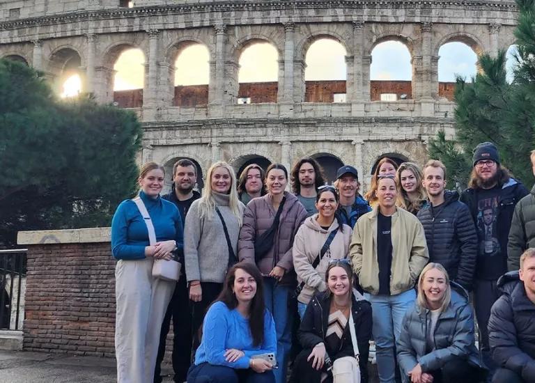 Topdeckers standing outside the Colosseum