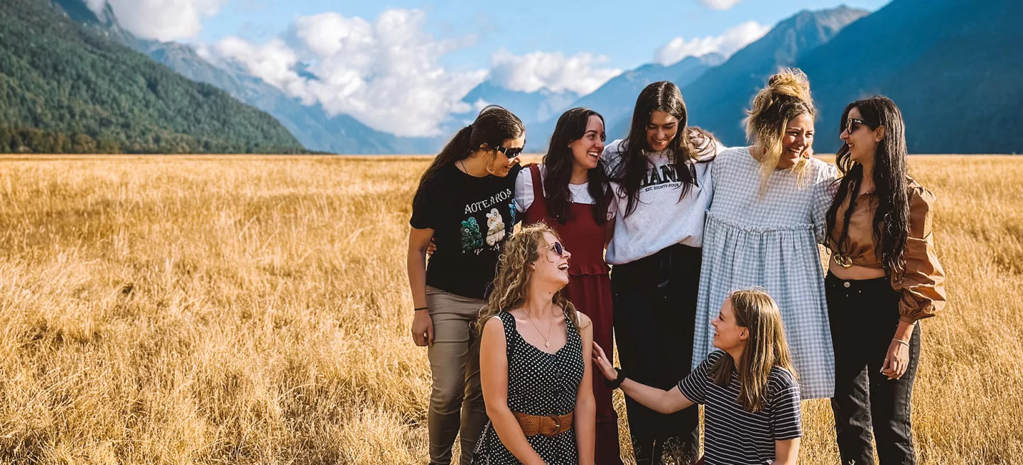 Small group of people standing together in Eglinton Valley in Fiordland National Park.