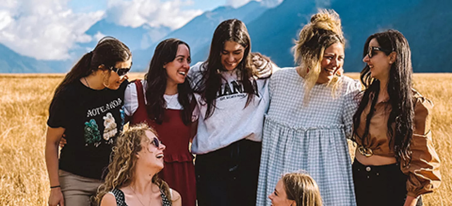 Small group of people standing together in Eglinton Valley in Fiordland National Park.