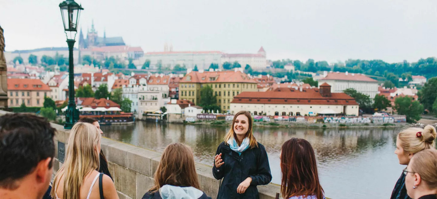 A tour group on Charles Bridge in Prague with the trip leader