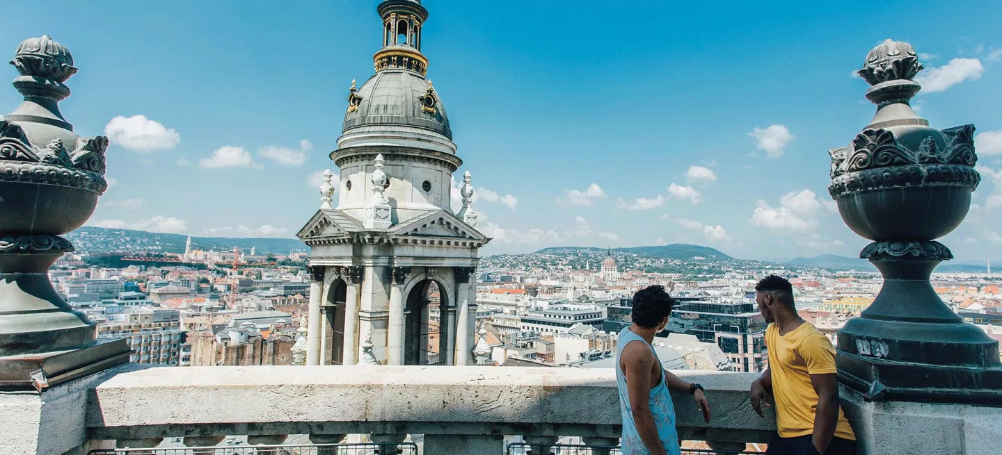People talking on a balcony at St Stephens Basilica in Budapest, Hungary.