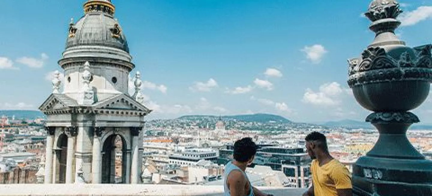 People talking on a balcony at St Stephens Basilica in Budapest, Hungary.