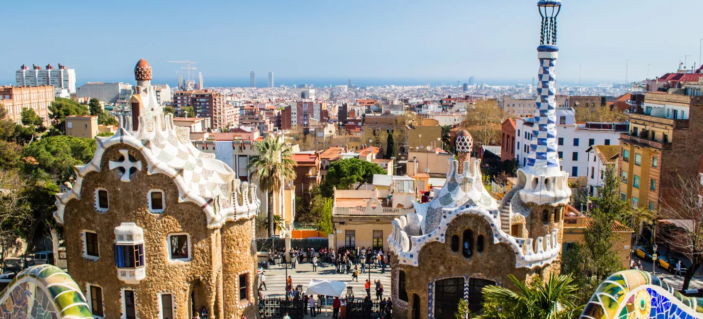 Entrance to Park Güell in Barcelona with gingerbread like houses and colourful tiling.