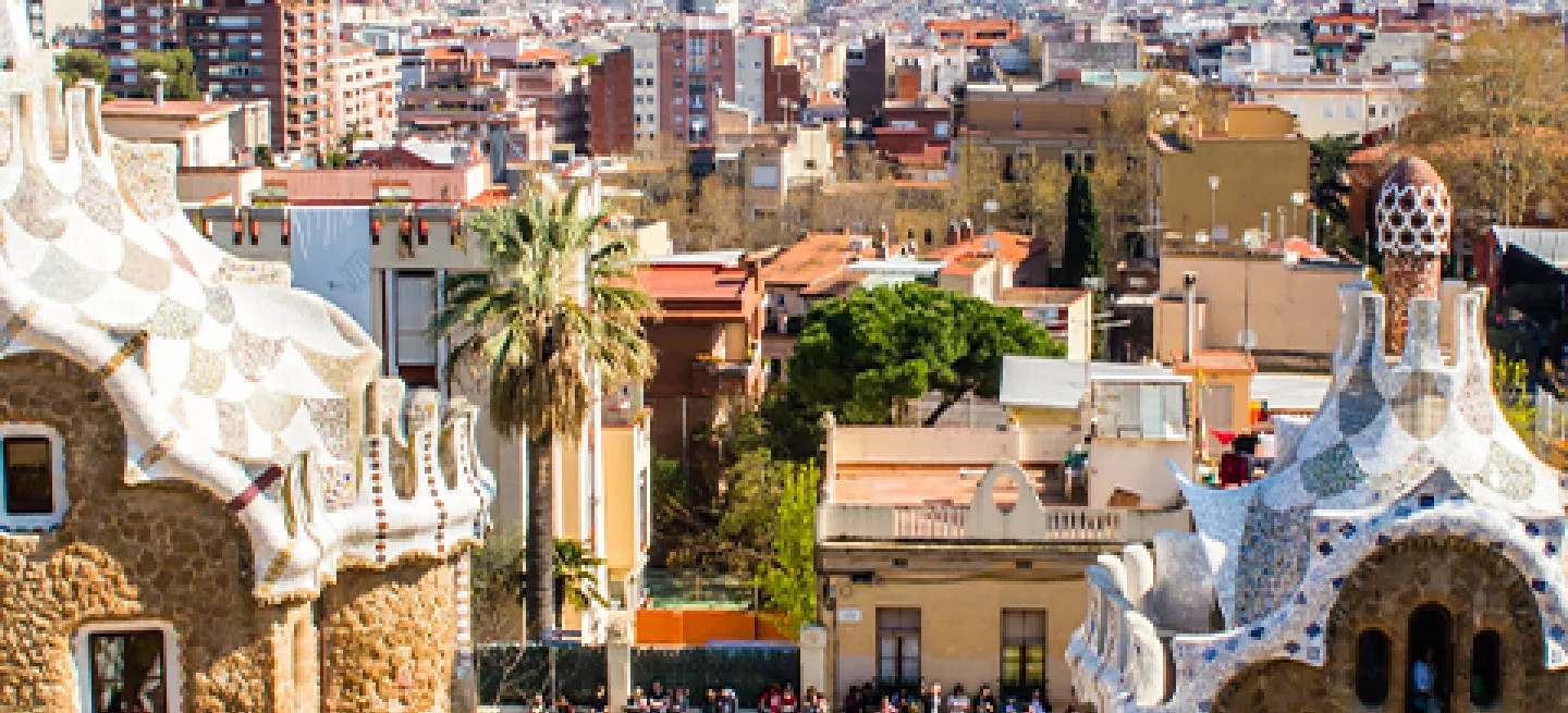 Entrance to Park Güell in Barcelona with gingerbread like houses and colourful tiling.
