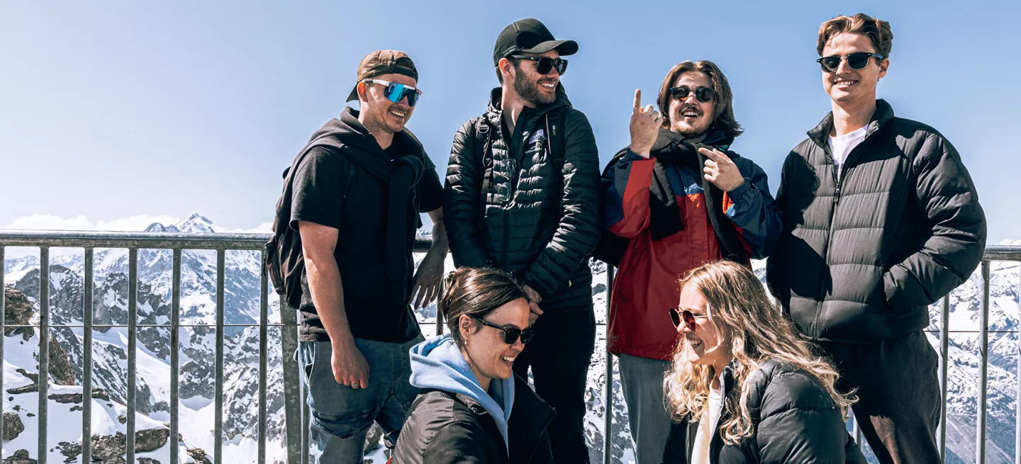 People posing together on the viewing platform overlooking the Swiss Alps.