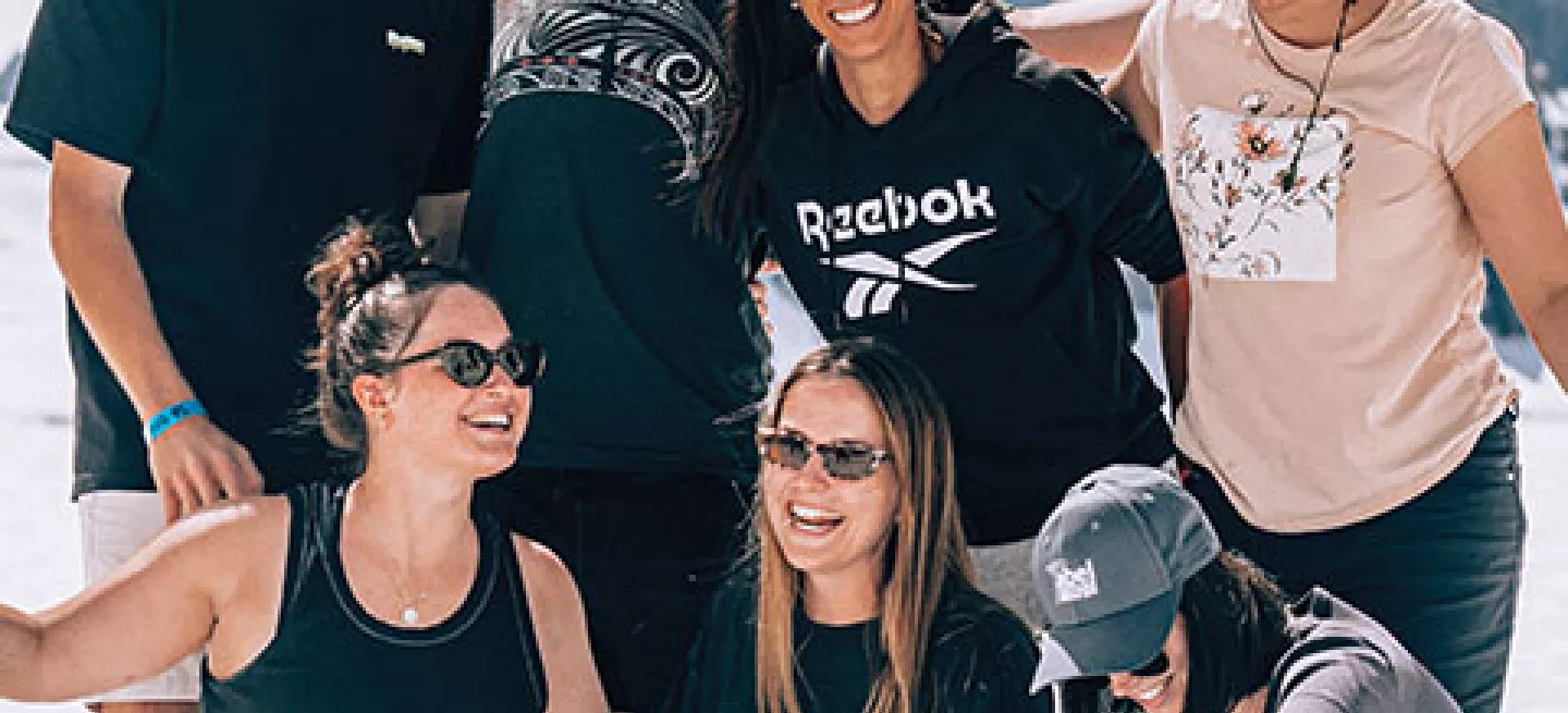 Group of people standing together on top of a glacier in New Zealand.