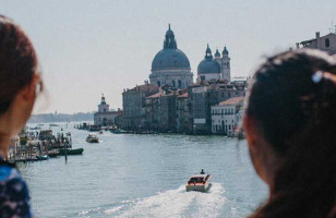 Two Topdeck travelers looking out over the famous Venice Canal.