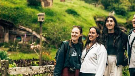 Four Topdeckers exploring the charming Hobbiton, as seen in the Lord of the Rings movies.