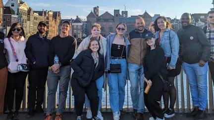 A group of Topdeck travellers posing for a photo together in Amsterdam.