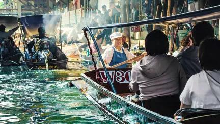 Boats filled with customers and traders fill the canals of the Damnoen Saduak floating market in Western Thailand.