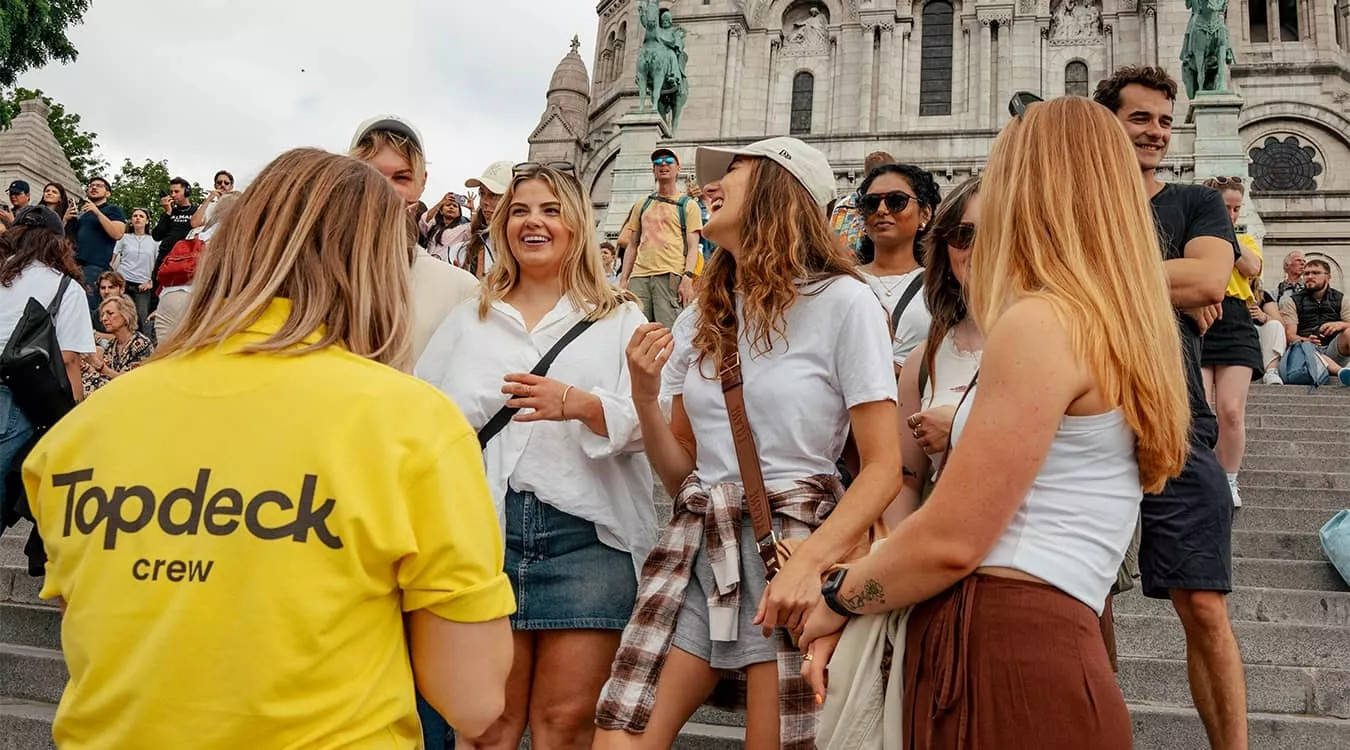 People standing together on the steps outside the Basilique du Sacré-Cœur de Montmartre in Paris.