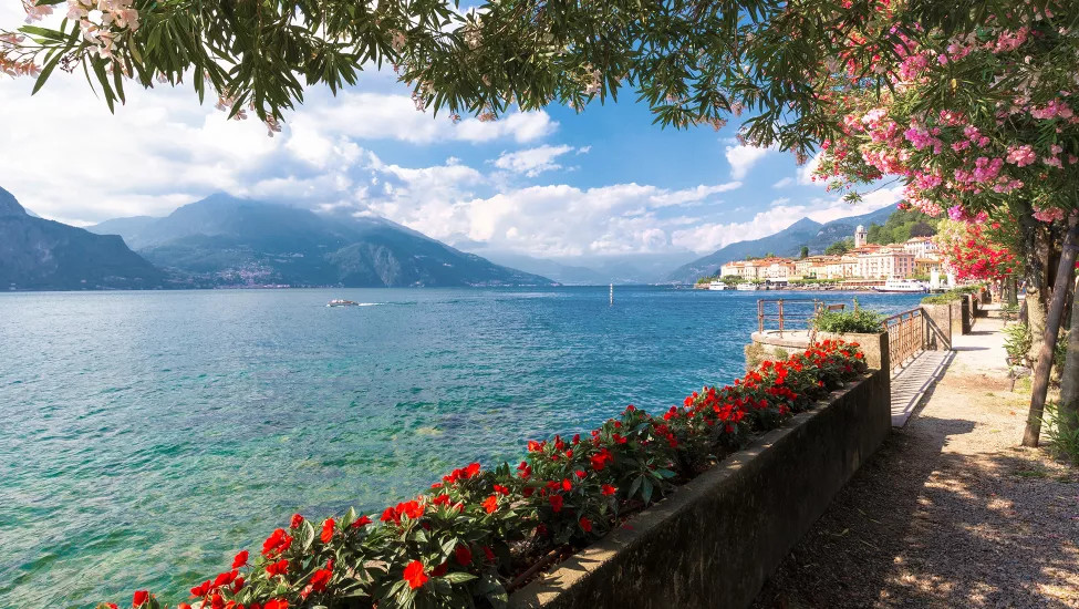 View of Lake Como with a flower planter on it’s edge.