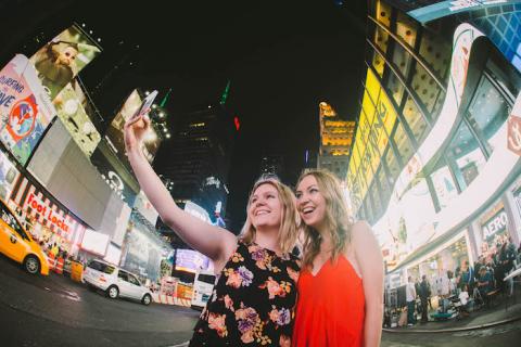 Two women taking a selfie in Times Square