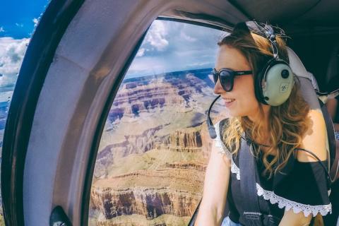 A woman sitting in a helicopter looking out the window