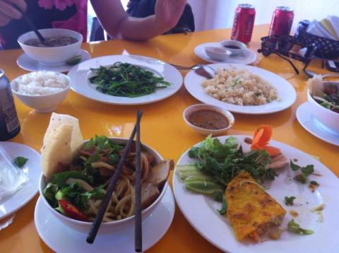 A table of food with Cao lầu noodles