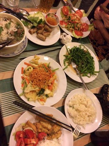 a table full of plates of Vietnamese food