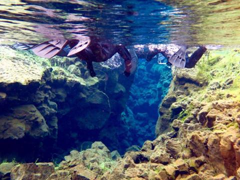 Two people scuba diving in Iceland