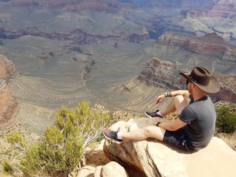 Man sitting looking at mountains