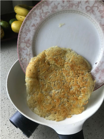 Rosti being slid off the plate onto another one