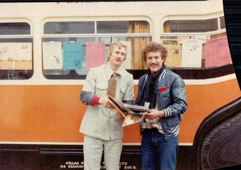 Skroo and Geoff standing next to the topdeck bus