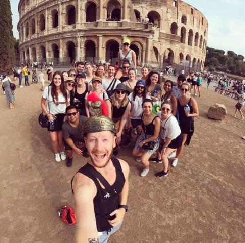 A group selfie in front of the Colosseum