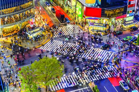 lots of people walking on the streets of Tokyo