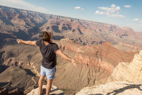 A man standing, taking in the view of the Route 66 canyon in Arizona