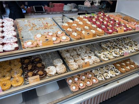 Rows of donuts on display in a shop