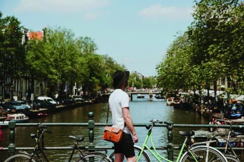 A person standing by the canal in Amsterdam