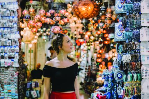 A girl looking at jewelry being sold in a market in Istanbul