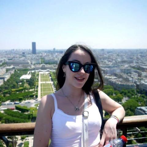 A woman smiling wearing glasses
