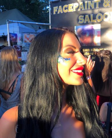 Woman at a festival with glitter on her cheek