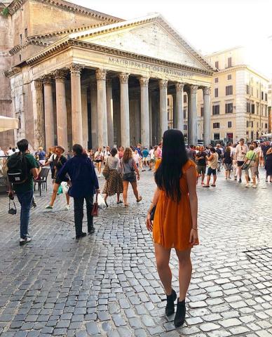 Woman standing in front of a Roman temple