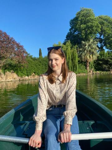 Woman smiling sitting on a rowing boat