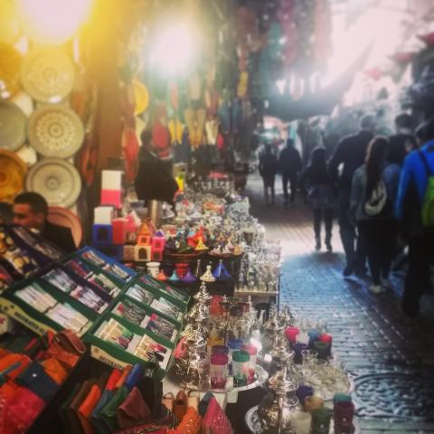 A stand at a market in Morocco selling bags, trinkets and similar items