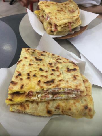 a hot-off-the-griddle flaky pastry filled with mystery meal, cheese, olives and an egg. 