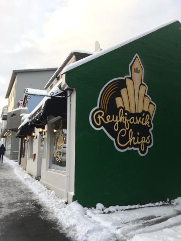  Side view of the restaurant, Reykjavik Chips, with their name and logo on display. In Iceland