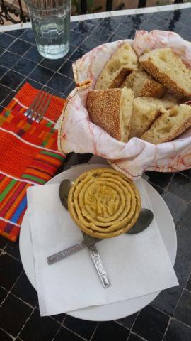 A bowl of hummus and a bowl of bread
