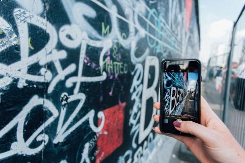 Someone taking a picture of street art