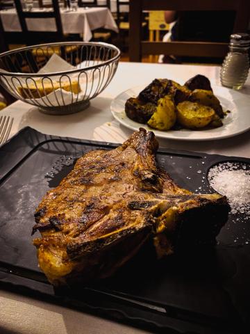 A slate of veal chop with roast potatoes 