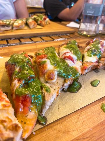 slices of margarita pizza with pesto