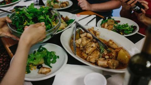 A table of food with chicken and salad