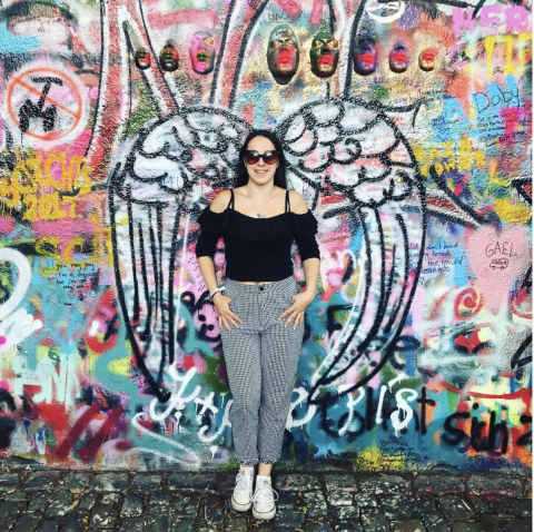 Woman in front of the John Lennon Wall