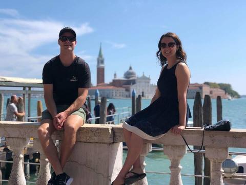 Couple sitting on a wall together