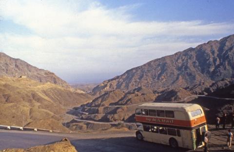Topdeck bus in 1982 driving through mountains