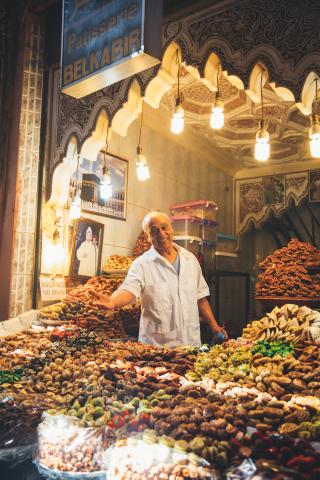 A man standing at a food stand