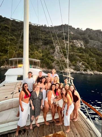 Group of people smiling on a sail boat in Turkey